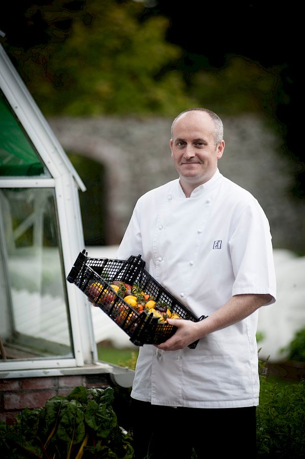 Stevie McLaughlin, Head Chef with a basket of fresh produce from the secret garden
